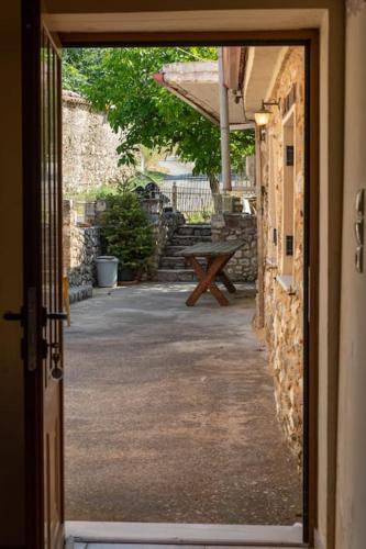 an open door to a patio with a picnic table at Taygeti's mountain lodge in Sparti
