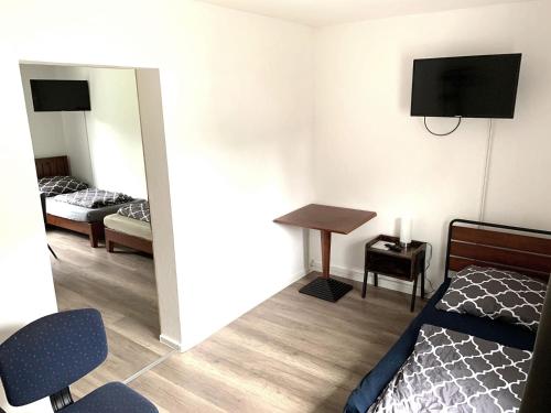 a bedroom with a bed and a desk and a tv at Monteur-Haus Linde in Biesenthal