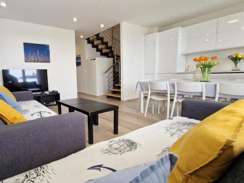 a living room with two couches and a dining room at Villa Miri III in Privlaka