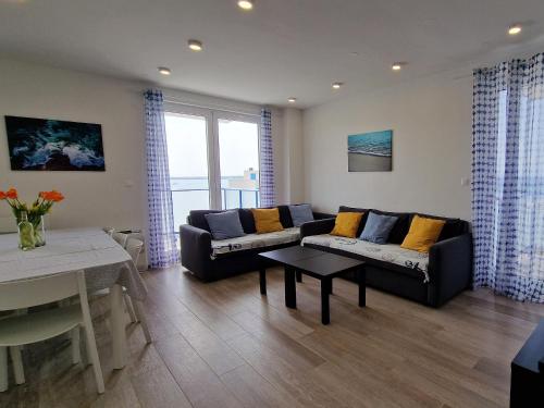 a living room with a couch and a table at Villa Miri III in Privlaka