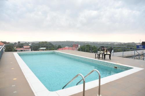 a swimming pool on top of a building at Hotel Orion Centrally near North Goa & Panjim in Porvorim