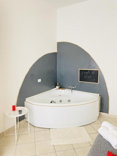 a bath tub in a room with a sign on the wall at JacuzziSuite in Livorno