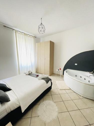 um quarto com uma cama grande e uma banheira em JacuzziSuite em Livorno