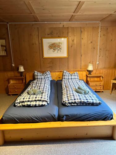 a bed with two pillows on it in a room at Landhauszauber Chumma 136m2 in Frauenkirch