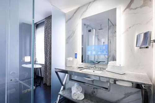 a bathroom with a sink and a mirror at The Sinclair, Autograph Collection in Fort Worth