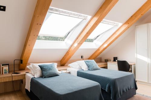 two beds in a attic room with skylights at Boutique Hotel HOH in Zagreb