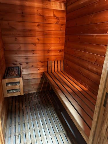 an inside of a wooden sauna with a stove at AM house in Burriana