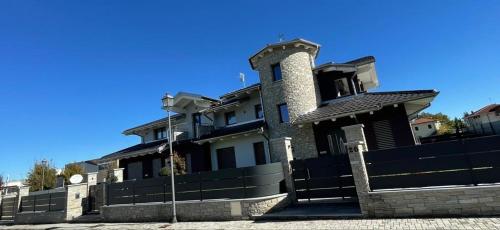 a large house with a fence in front of it at Bed and breakfast Ma.Gi.A in Cuneo