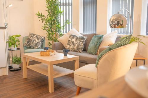a living room with a couch and a table at Principality Suites; Three Bed By Property Promise in Cardiff