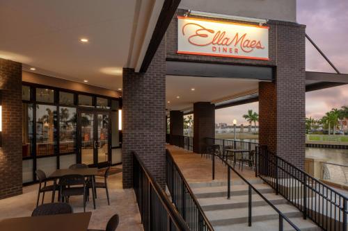 a restaurant with a sign on the side of a building at Luminary Hotel & Co., Autograph Collection in Fort Myers