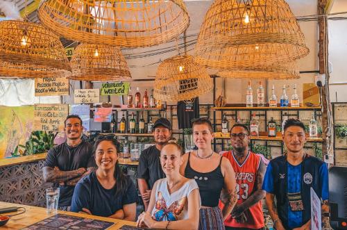 a group of people standing at a bar at Yellow Star Hostel in Kampot