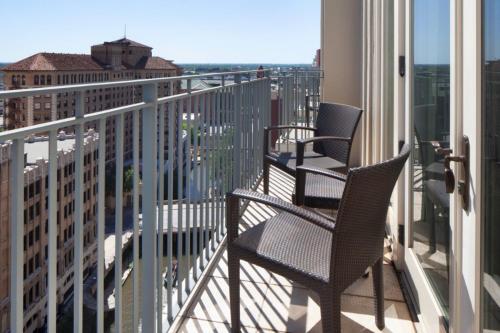two chairs on a balcony with a view of a city at The Westin Riverwalk, San Antonio in San Antonio