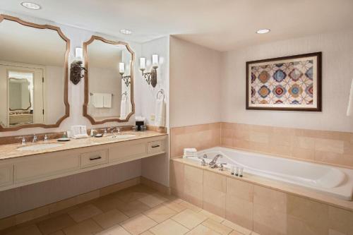 a bathroom with a tub and two sinks and a bath tub at The Westin Riverwalk, San Antonio in San Antonio