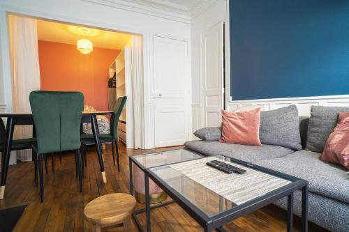a living room with a couch and a table at Cozy love cocoon in Boulogne-Billancourt's heart in Boulogne-Billancourt