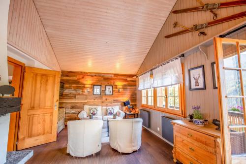 a room with a table and chairs in a tiny house at Chalet La Neuf in Blitzingen