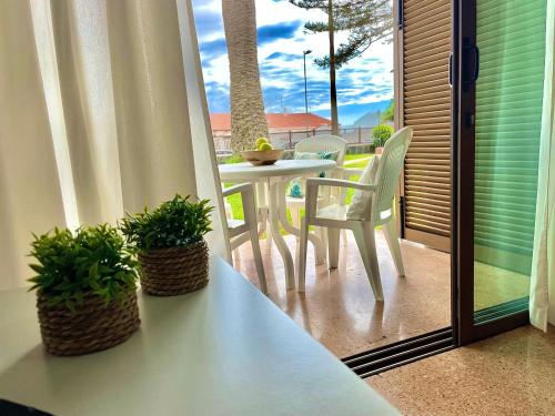 a balcony with a table and chairs on a patio at Los Balandros 106 by SunHousesCanarias in San Agustin