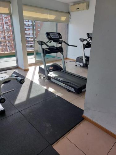 a gym with several exercise bikes in a room at Amplio departamento, piso alto, luminoso ! in Buenos Aires