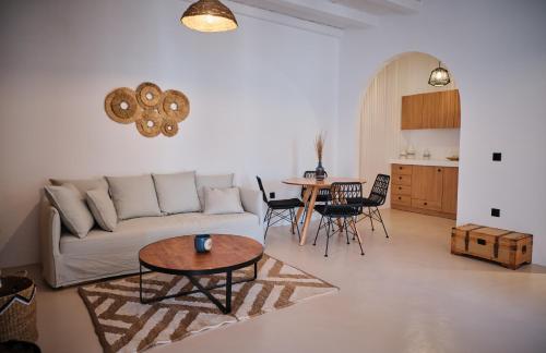 a living room with a couch and a table at Eden Kythira in Dhiakofti