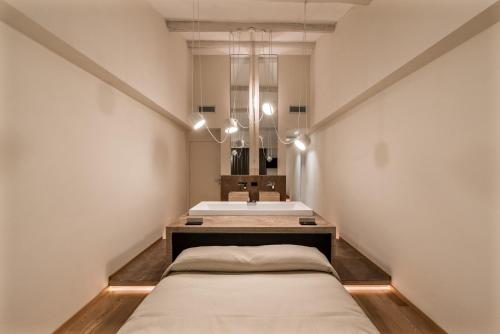 a bathroom with a bed and a sink in it at Resort Miramonti in Forte dei Marmi