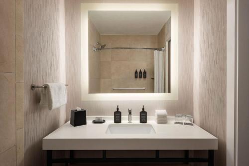 a bathroom with a white sink and a mirror at Sheraton La Jolla in San Diego