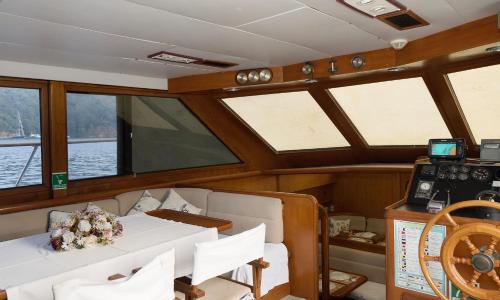 a boat with a table and chairs and windows at Vira Yacht in Göcek