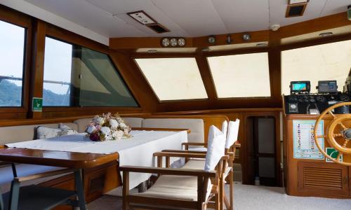 a table and chairs in a boat with windows at Vira Yacht in Göcek