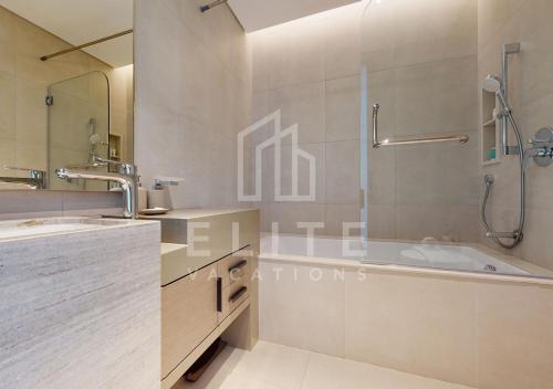 een badkamer met een douche, een wastafel en een bad bij 2 BDR Apartment in ADDRESS BEACH RESORT in Dubai