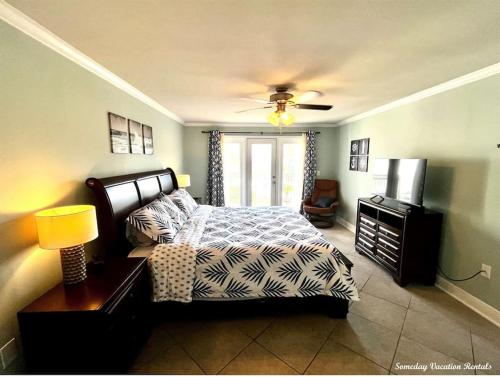 a bedroom with a bed and a television in it at Biloxi Beach-Good Vibes Condo in Biloxi