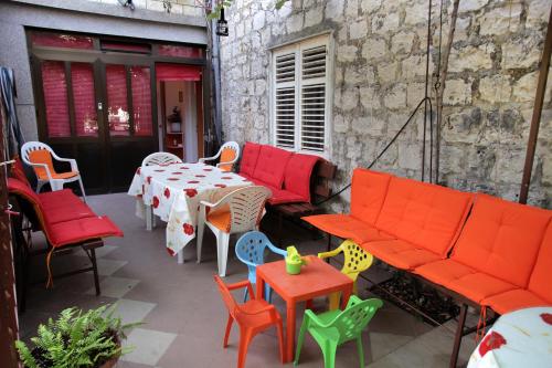 a patio with colorful furniture and a table and chairs at Apartment Duje & Josipa in Trogir