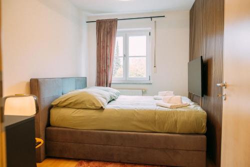a bedroom with a bed and a window at Luxury Suite - Therme ED - Messe MUC - Parken - WLAN in Erding