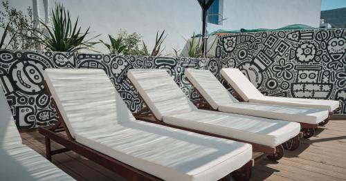 a row of chaise lounge chairs sitting on a deck at Eden Kythira in Dhiakofti