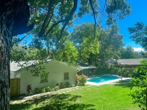 a house with a yard and a swimming pool at 4 Bedroom Clearwater Vacation Home with Amazing Backyard in Clearwater