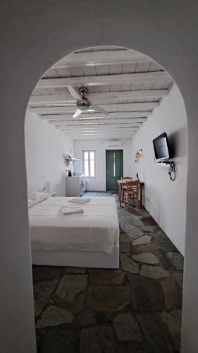 a bedroom with a bed and a tv in a room at Spice Suites-Lime in Amorgos