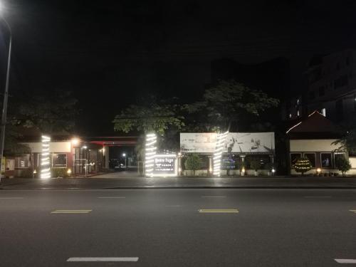 an empty street at night with a building with lights at Twin Palms Resort in Sihanoukville