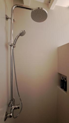 um chuveiro na casa de banho com uma cabeça de chuveiro em Spice Suites-Lime em Amorgós