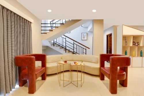 a living room with a couch and two chairs at Lemon Tree Suites, Whitefield, Bengaluru in Bengaluru