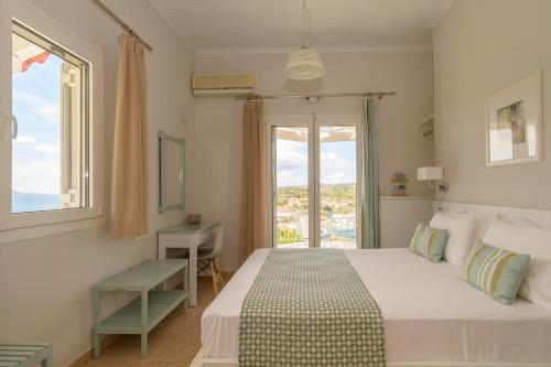 a bedroom with a bed and a window and a desk at Pelagia's Apartments Finikounda in Finikounta