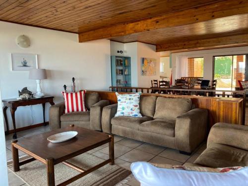 Gansbaai的住宿－Rots en See，客厅配有两张沙发和一张桌子