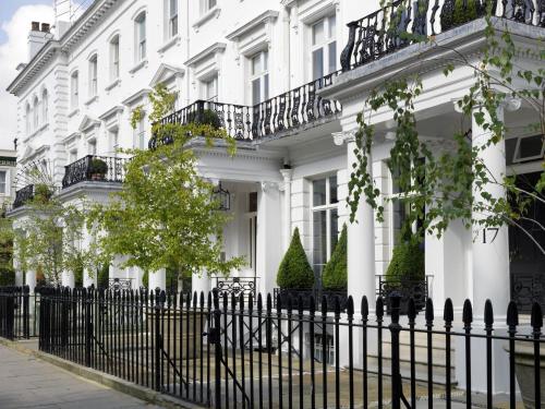 a white building with a fence in front of it at Number Sixteen, Firmdale Hotels in London