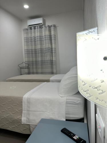 a room with two beds and a remote control at A Due Passi dal Mare in Catanzaro