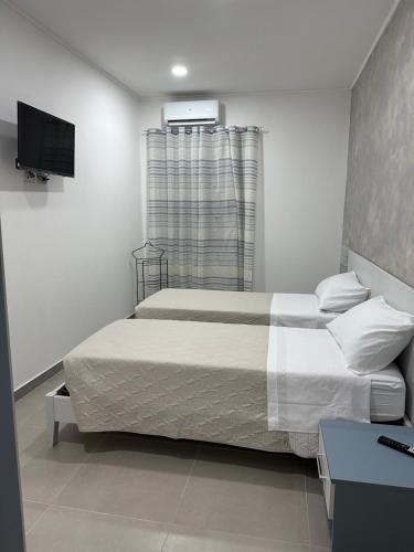 a bedroom with a bed and a television in it at A Due Passi dal Mare in Catanzaro
