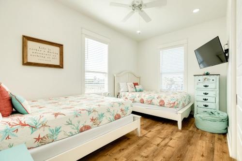 a bedroom with two beds and a tv in it at Boats Fishing and Exquisite Decor in Freeport