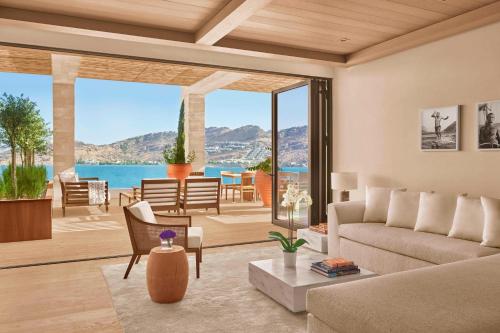 a living room with a view of the ocean at The Bodrum EDITION in Yalıkavak