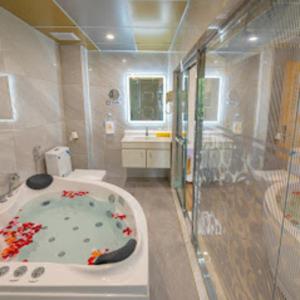 a bathroom with a tub and a shower and a sink at Khách Sạn Cường Thanh 3 in Ho Chi Minh City