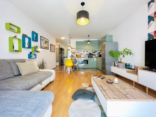 a living room with a couch and a coffee table at Corvin City Apartment - FREE PARKING- in Budapest