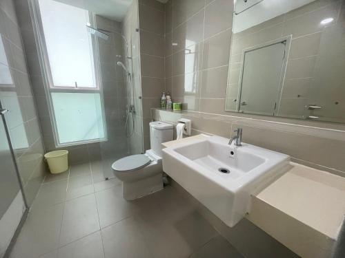 a white bathroom with a sink and a toilet at Sutera Avenue Kota Kinabalu in Kota Kinabalu