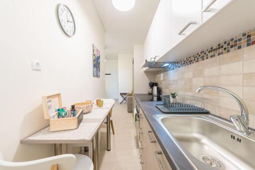 a kitchen with a sink and a counter at Over The Town Urban 1BR Apt. 7' to Thiseio Metro in Athens