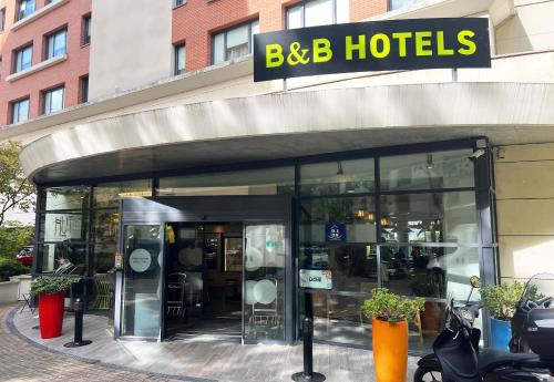 a store front of a building with a sign on it at B&B HOTEL Rueil-Malmaison Gare in Rueil-Malmaison