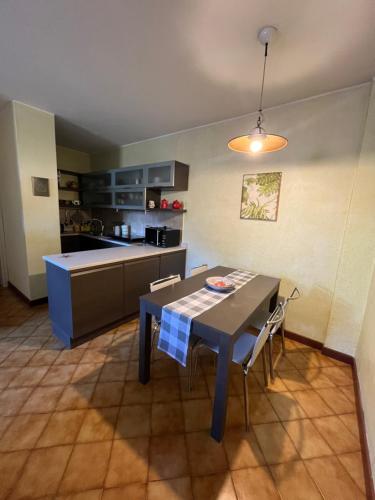 a kitchen with a table and chairs in a room at La nostra casa la vostra casa Cir00023 in Saint Vincent