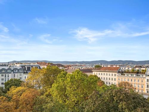 a view of a city with trees and buildings at SKY9 Penthouse Apartments in Vienna